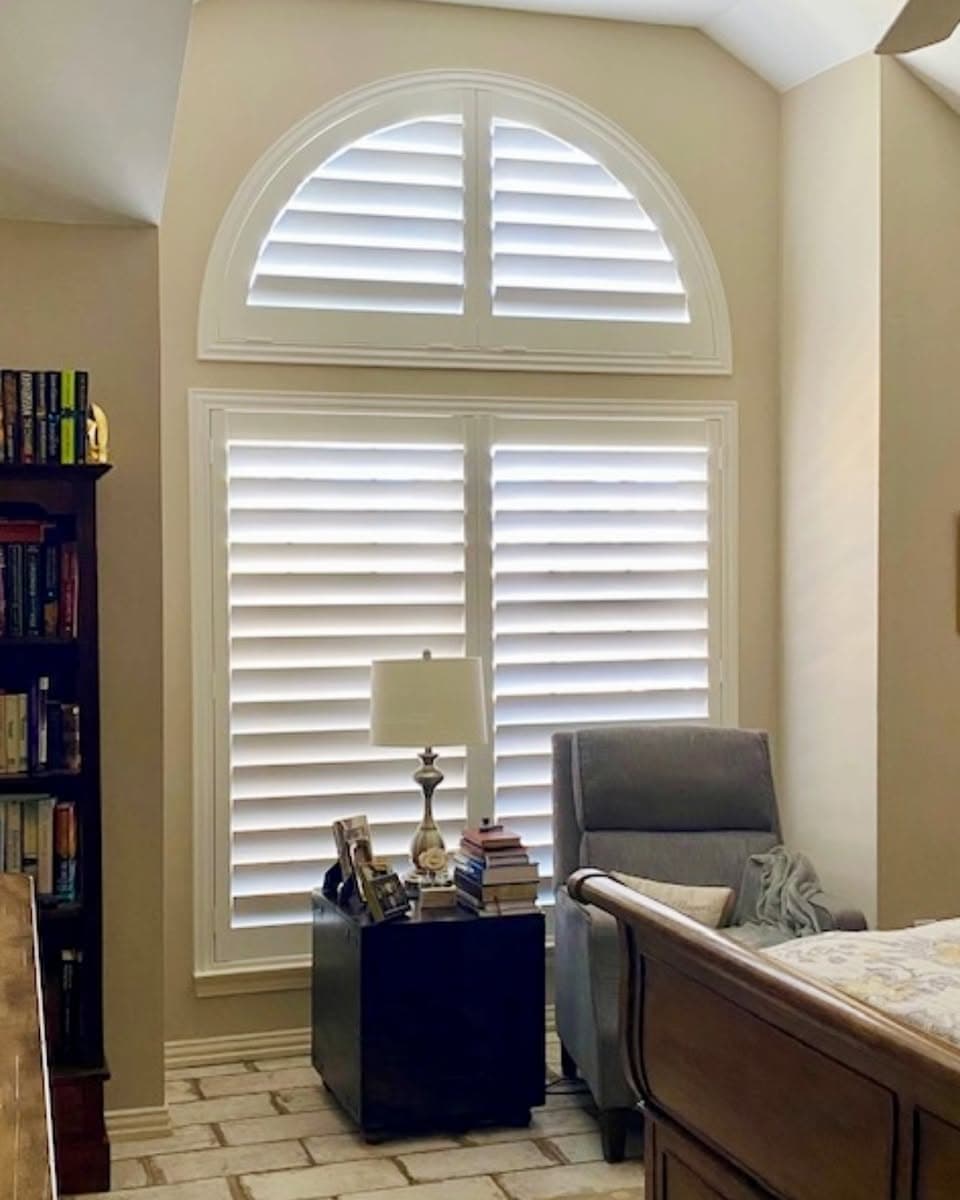 Custom white plantation shutters framing windows in a bright Lakewood Ranch kitchen