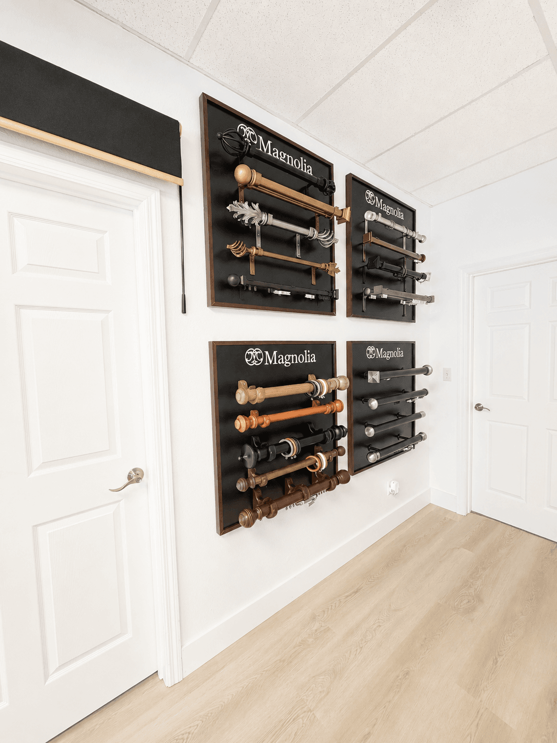 Display boards of Magnolia decorative drapery hardware and finials mounted in the showroom.