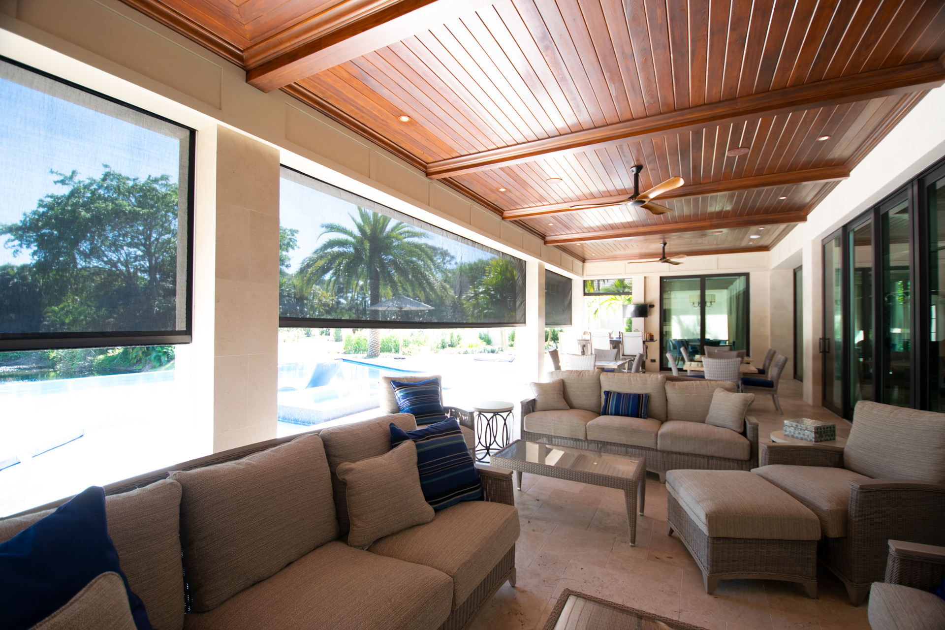 Motorized storm screen deployed over a poolside lanai opening on a Sarasota home