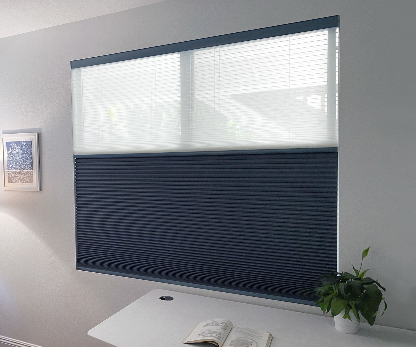 Cellular honeycomb shades with a soft pleated texture on a bright bedroom window