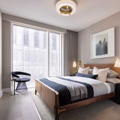 Modern city bedroom with a roller shade and side drapery on a floor-to-ceiling window