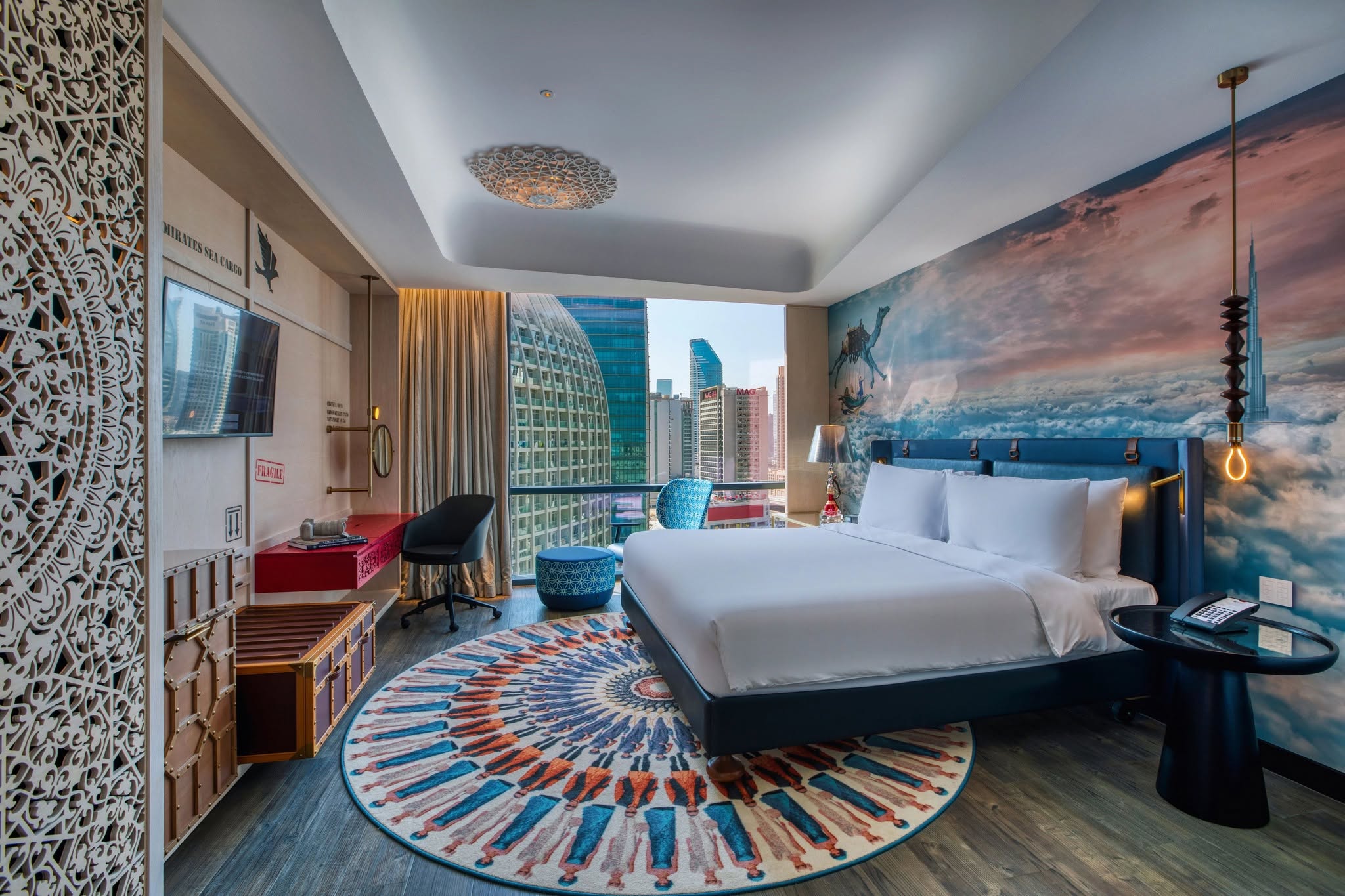 Luxury hotel-style bedroom with gold drapery on floor-to-ceiling city-view windows