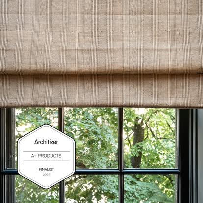 Natural woven shade over a window with an Architizer A+ Products Finalist 2024 badge