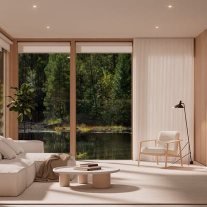 Serene living room with roller and sheer shades framing a forest and lake view