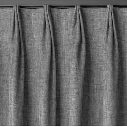 Close-up of gray pinch-pleat drapery fabric hanging in even folds