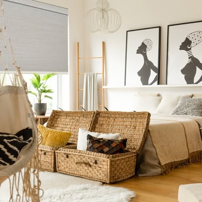 Neutral cellular honeycomb shade in a boho bedroom with woven baskets and framed art