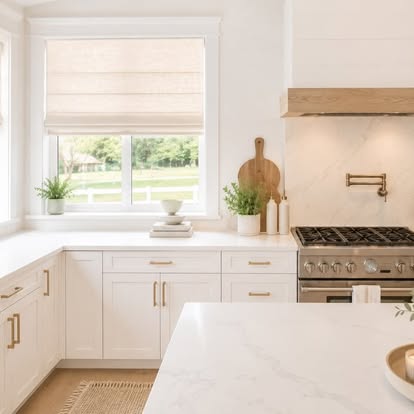 Natural woven Roman shade over a kitchen sink window in a bright white-and-oak kitchen