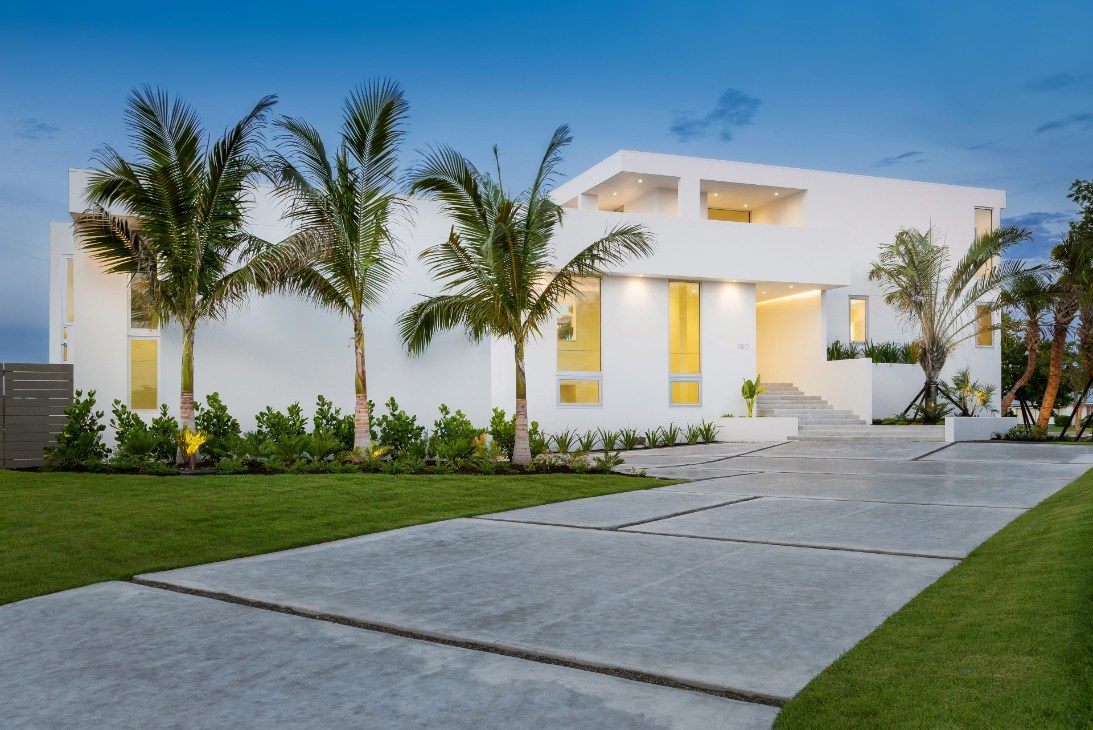 Home exterior showcasing PGT WinGuard aluminum casement, awning, and picture windows