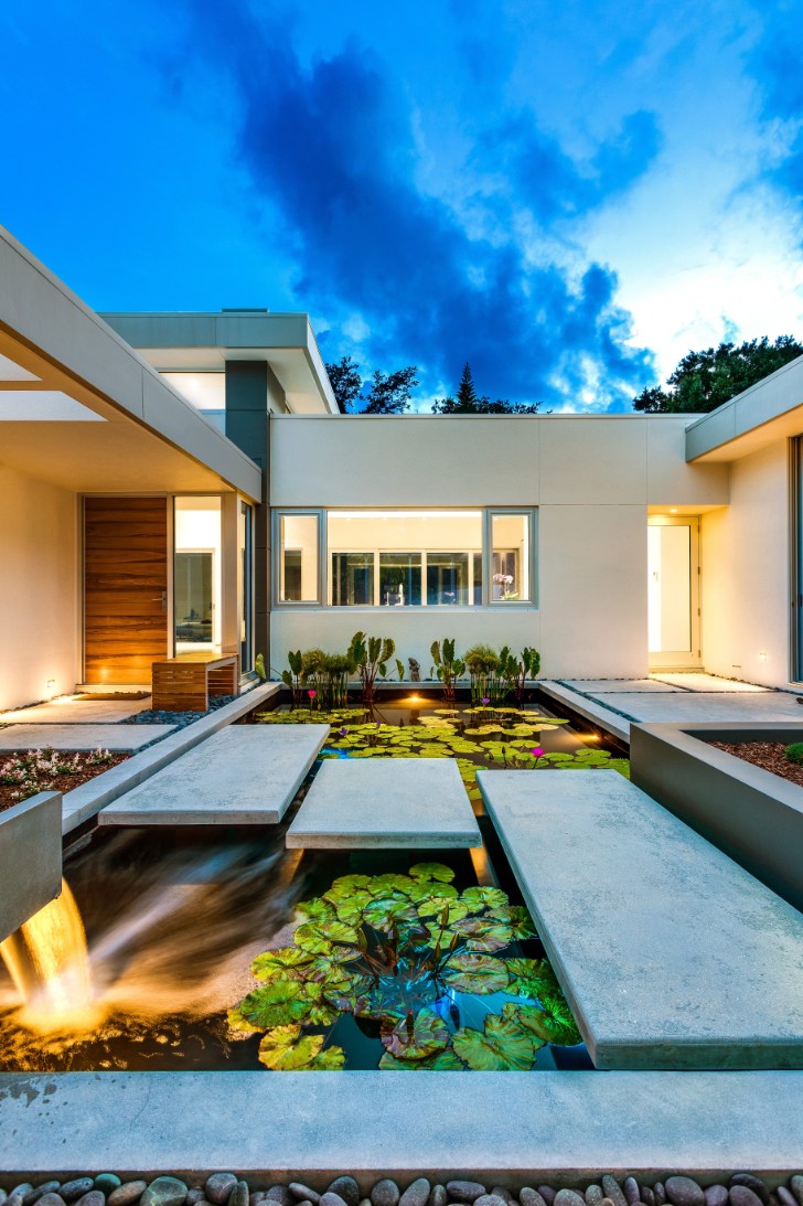Exterior of a home with PGT WinGuard aluminum casement and picture windows