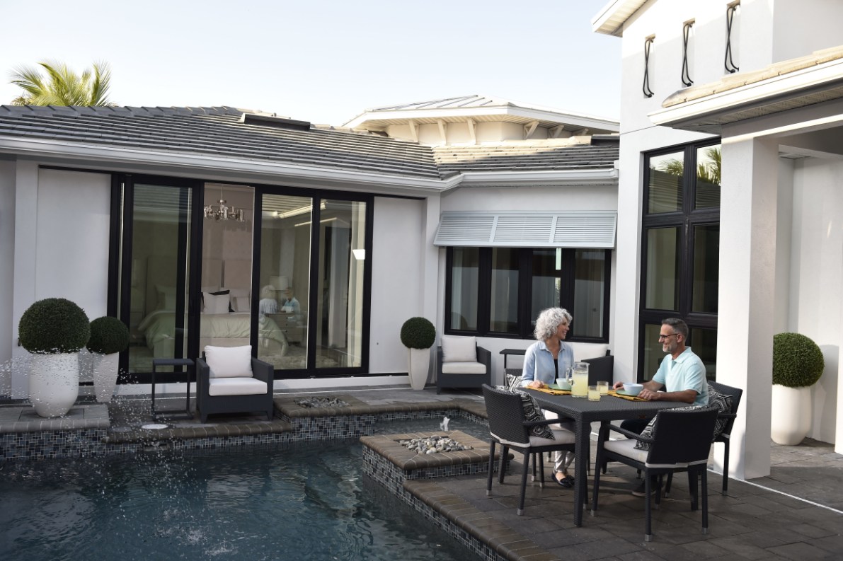 Home exterior with PGT WinGuard vinyl sliding glass doors and windows
