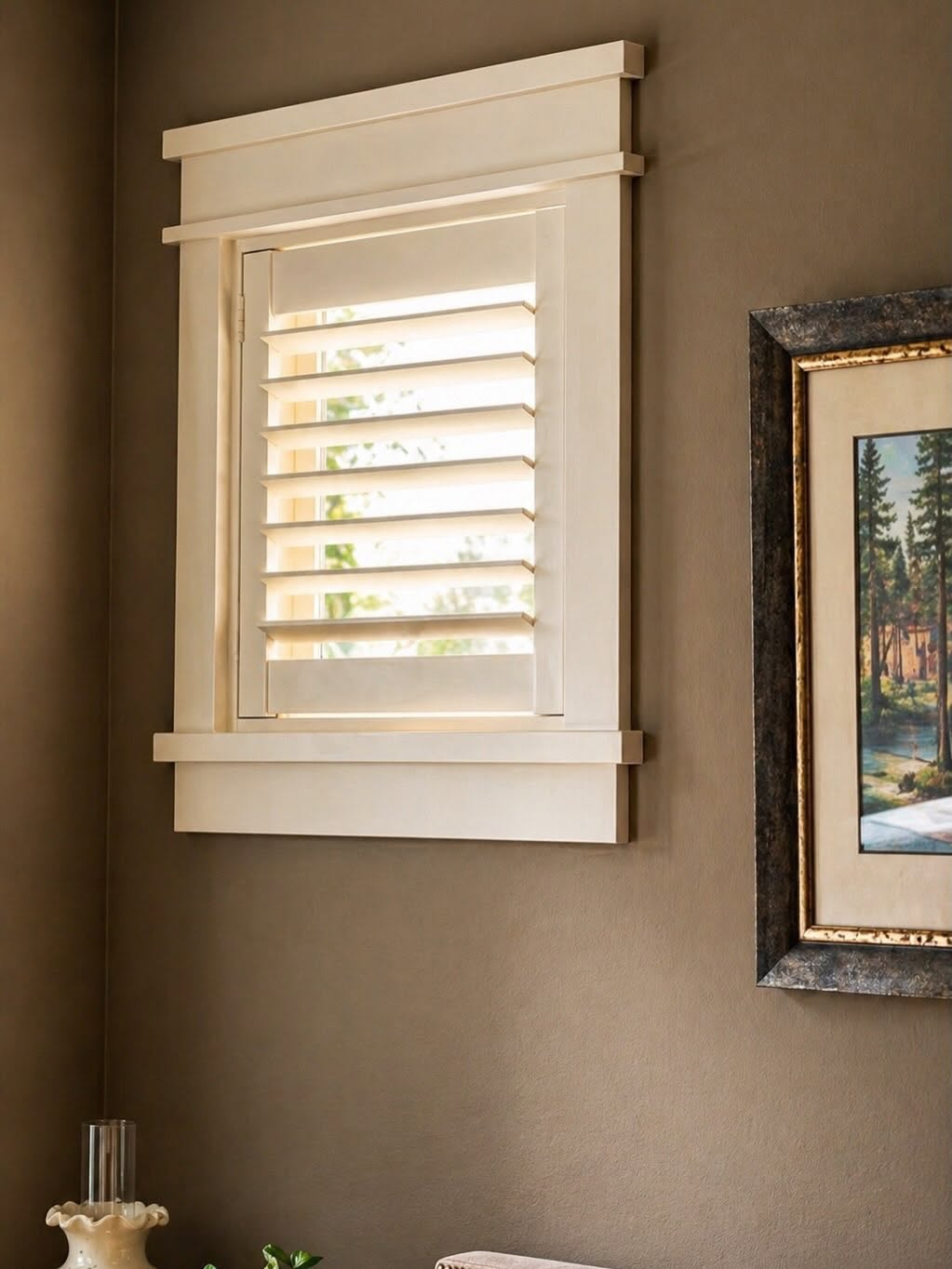 Custom white Norman plantation shutters on tall windows in a luxury Sarasota home by Sarasota Window Blinds