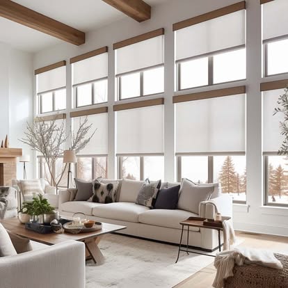 Wall of tall windows fitted with white roller shades in a bright modern living room